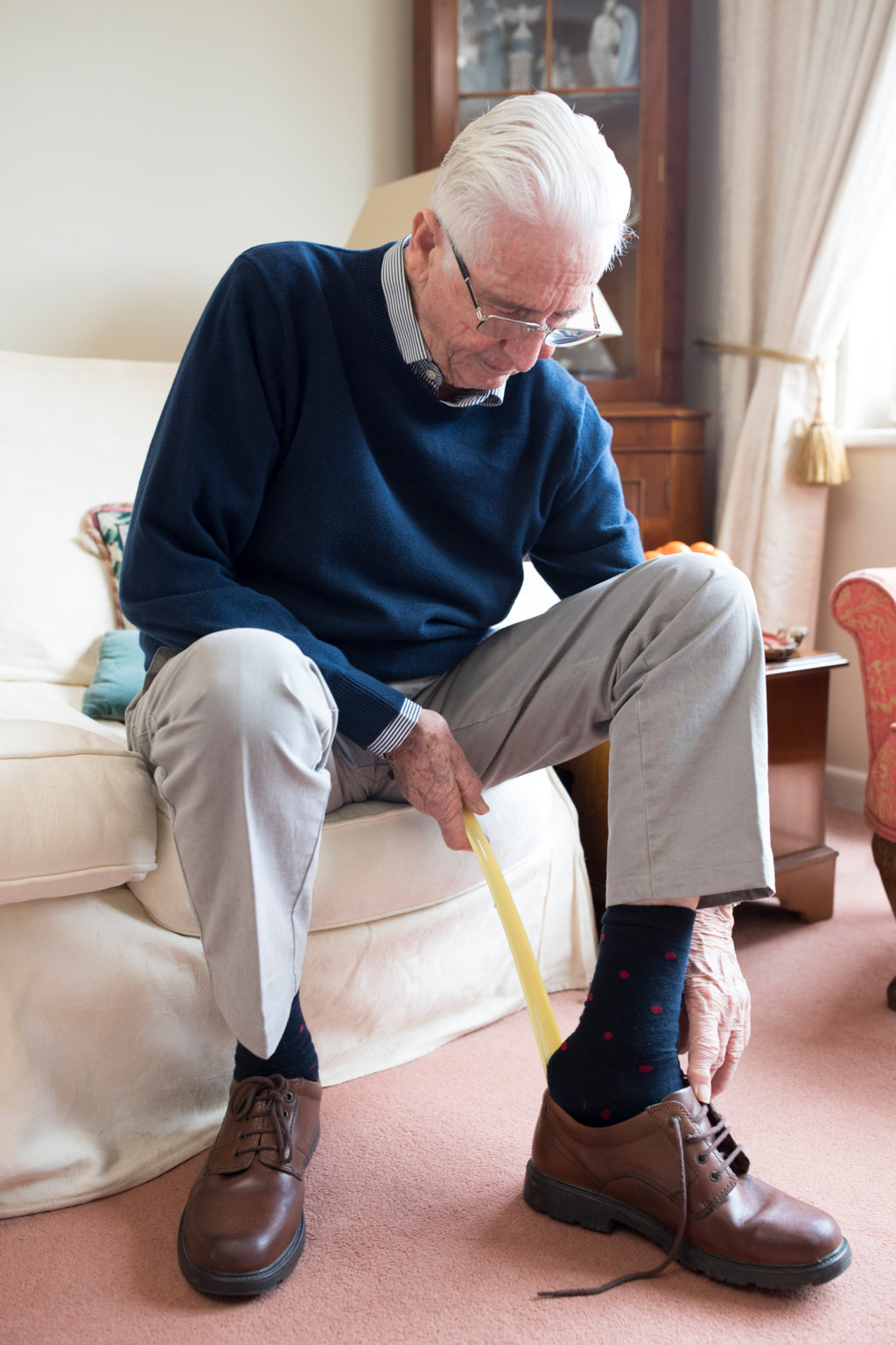Elderly putting on shoe